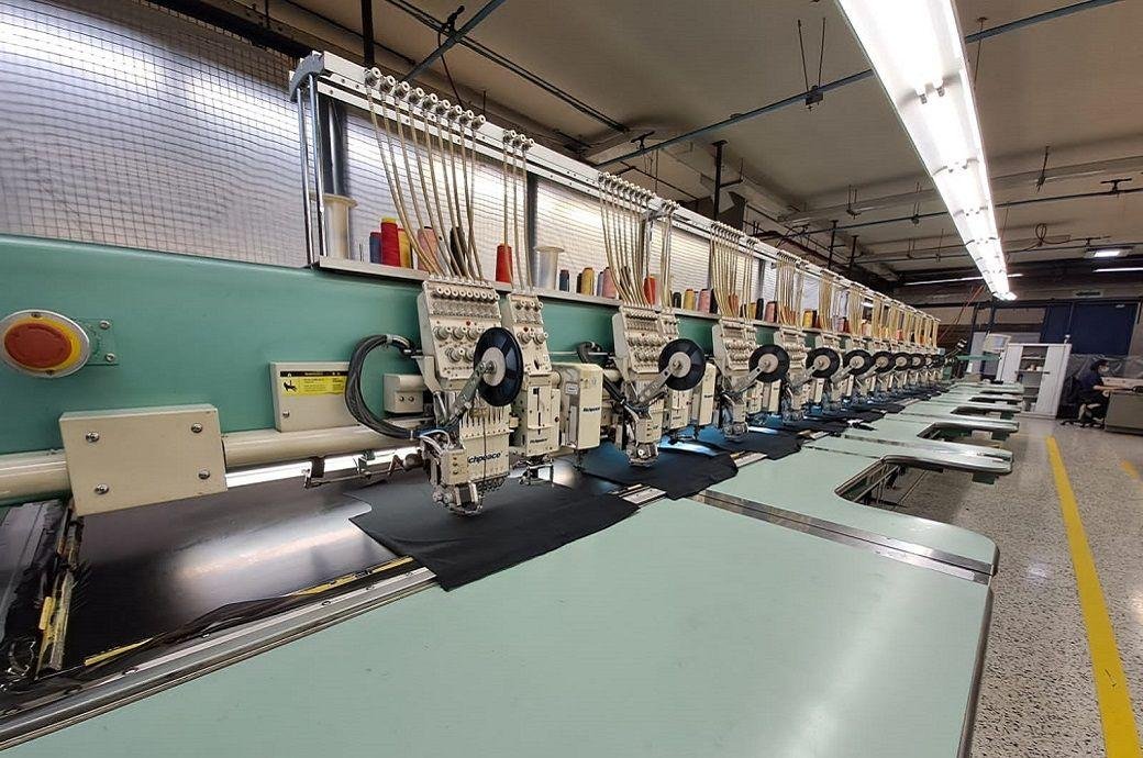 Row of embroidery machines on the Toshiko factory floor