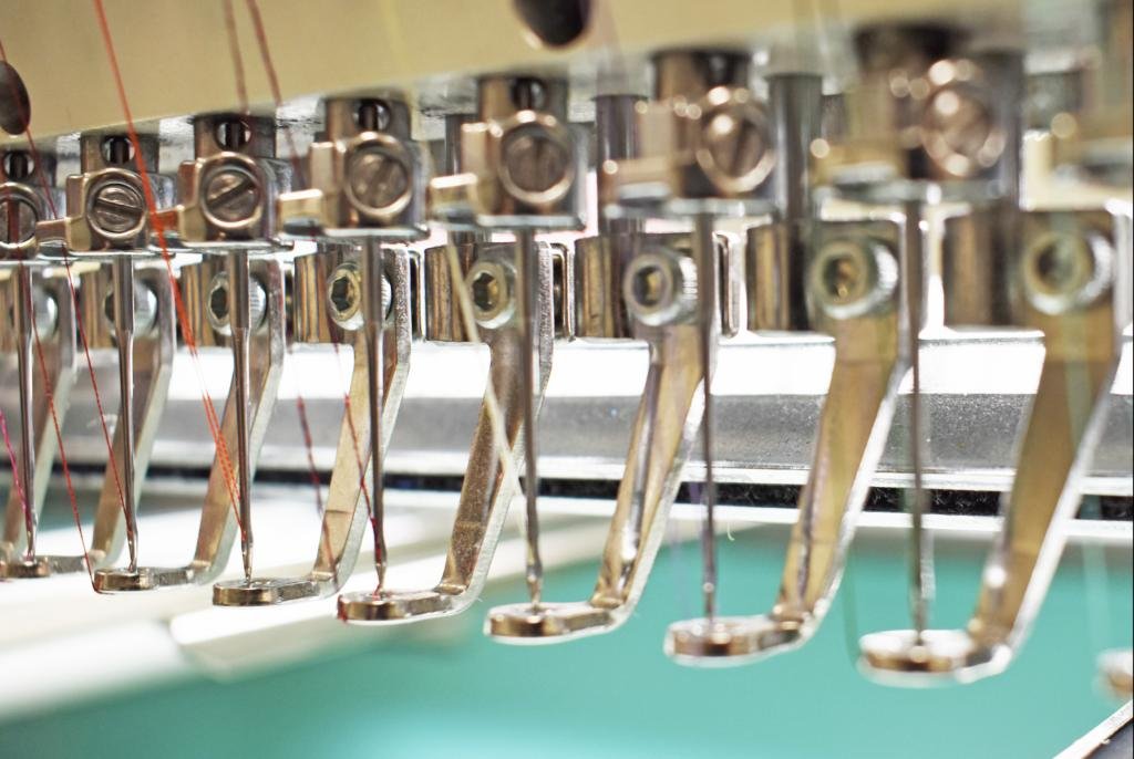 Row of embroidery machine needles, threaded and ready